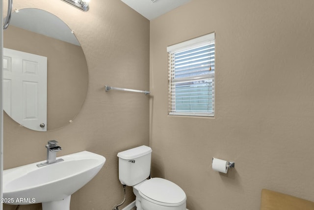 bathroom with toilet and a sink