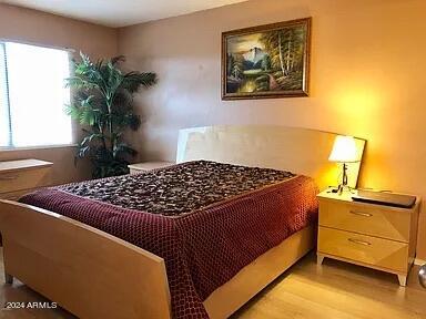 bedroom with light wood-type flooring