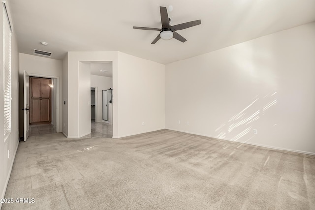 spare room featuring ceiling fan and light colored carpet