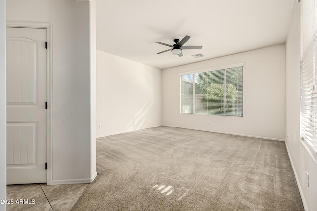 carpeted empty room featuring ceiling fan