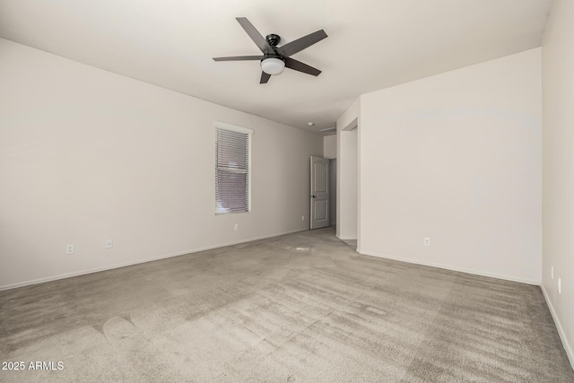 empty room with ceiling fan and carpet flooring