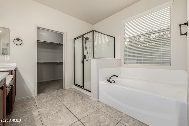 bathroom featuring vanity, tile patterned floors, and plus walk in shower