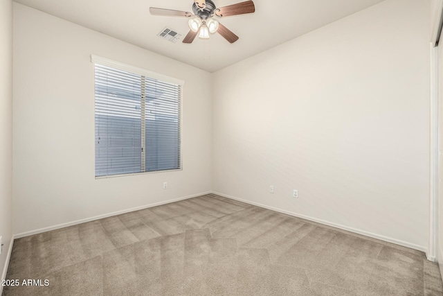 carpeted spare room featuring ceiling fan