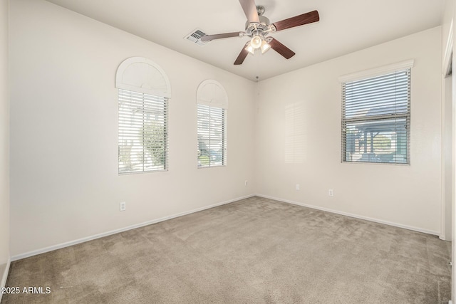 unfurnished room with light carpet and ceiling fan