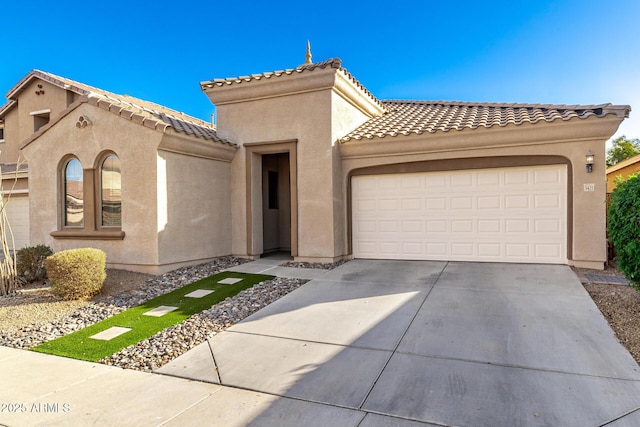 mediterranean / spanish-style home featuring a garage