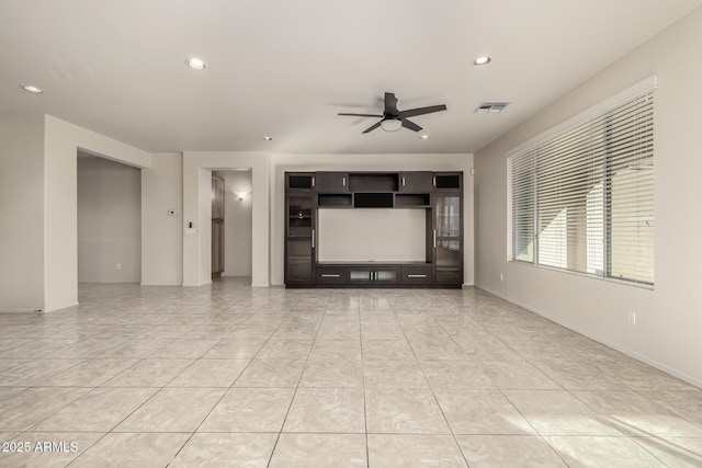 unfurnished living room with ceiling fan and light tile patterned flooring