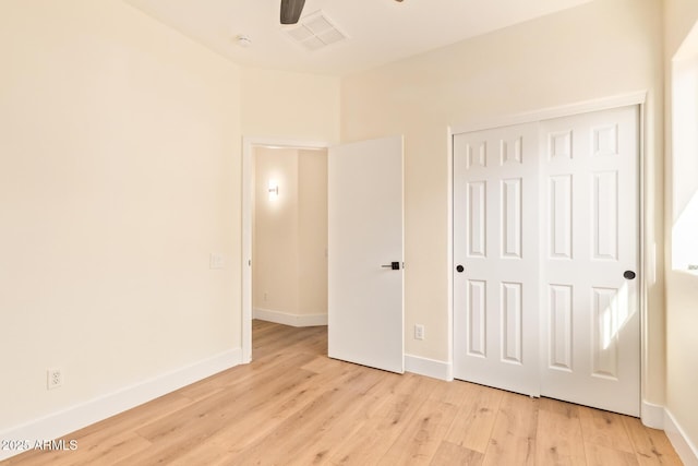 10276 E Meandering Trail Ln, Gold Canyon, AZ 85118 - unfurnished bedroom featuring light wood-style floors, baseboards, a closet, and ceiling fan