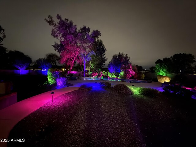 690 E Seattle Slew Ln, Gilbert, AZ 85296 - pool at night with a pool and a patio area