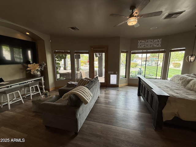 living room with visible vents, baseboards, a ceiling fan, and wood finished floors