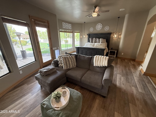 bedroom with baseboards, wood finished floors, a ceiling fan, and access to exterior