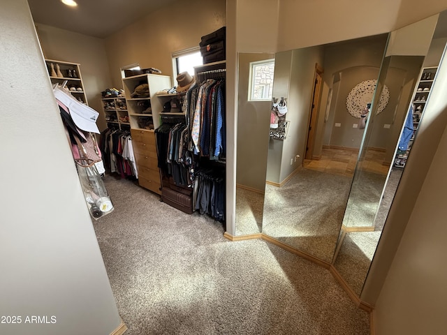 walk in closet featuring carpet