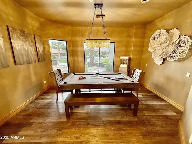 dining area featuring visible vents, wood finished floors, and baseboards