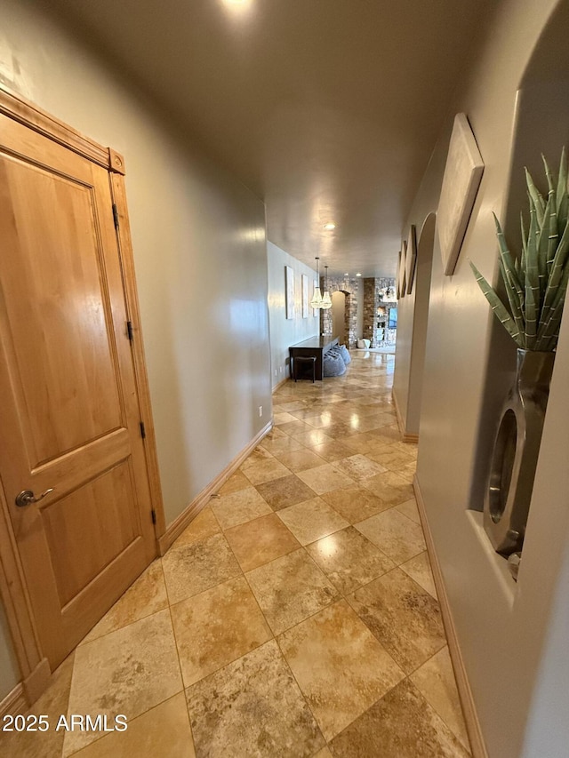 hallway featuring baseboards