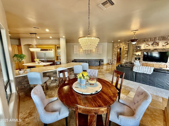 dining area with a chandelier, visible vents, and recessed lighting