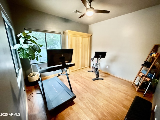 workout area featuring visible vents, wood finished floors, baseboards, and ceiling fan