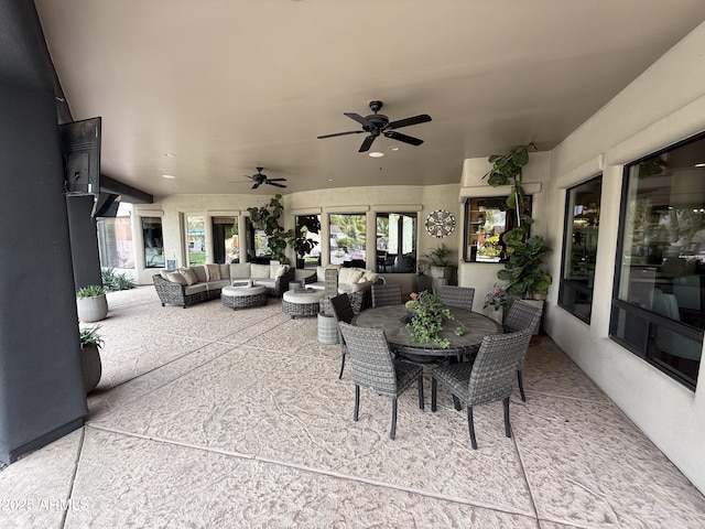 view of patio / terrace with an outdoor living space, ceiling fan, and outdoor dining space