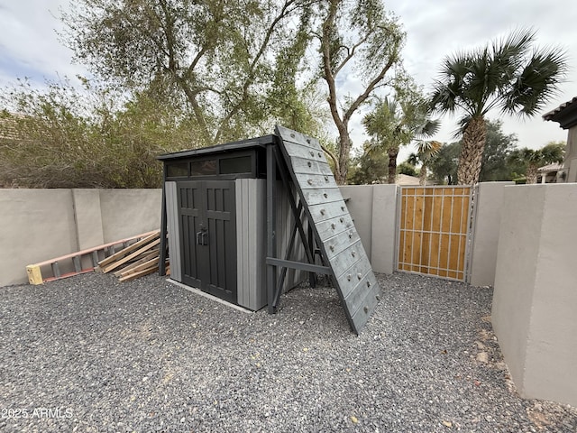 view of outbuilding featuring a gate and fence