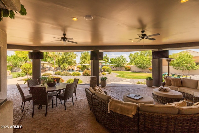 690 E Seattle Slew Ln, Gilbert, AZ 85296 - fenced backyard with a ceiling fan, outdoor dining space, an outdoor living space, and a patio