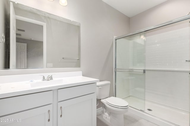 bathroom with vanity, an enclosed shower, and toilet