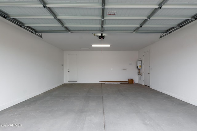 garage with tankless water heater and a garage door opener