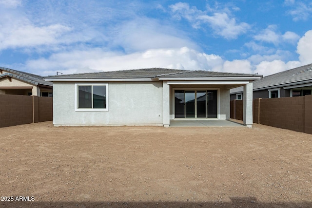 rear view of property featuring a patio area