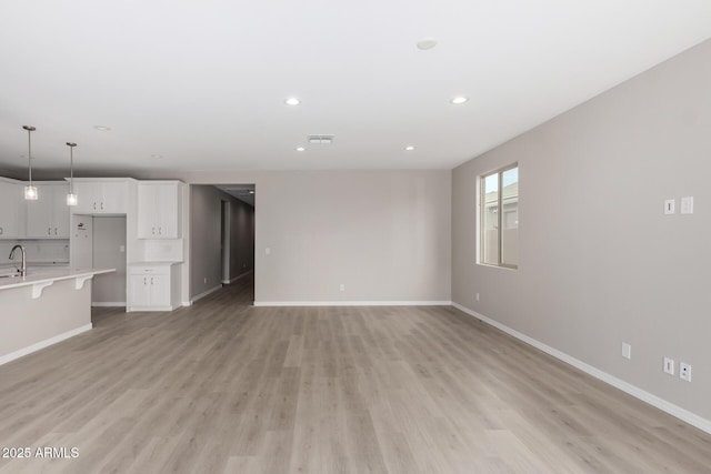 unfurnished living room with light hardwood / wood-style floors