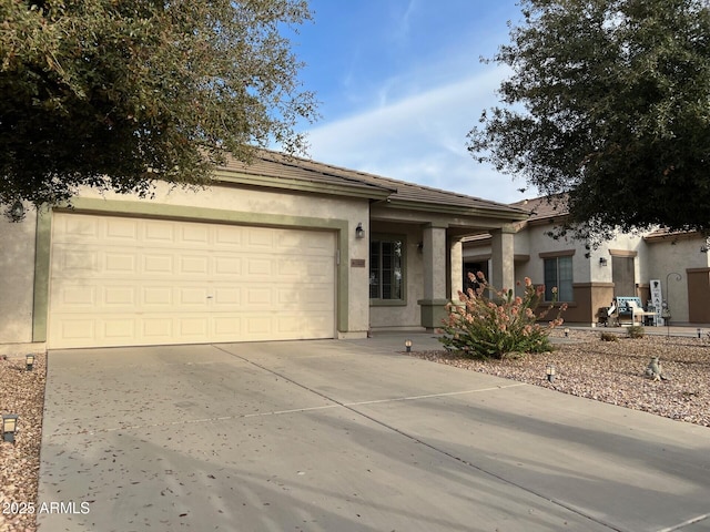 ranch-style house with a garage, concrete driveway, and stucco siding