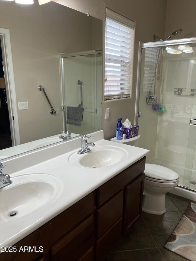 full bathroom featuring a sink, a shower stall, and double vanity