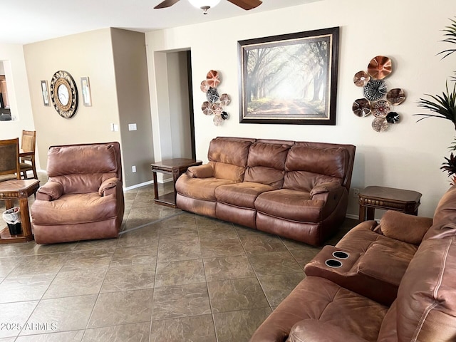 living room featuring a ceiling fan and baseboards