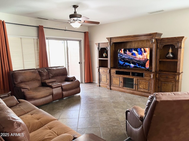 living room featuring ceiling fan and visible vents