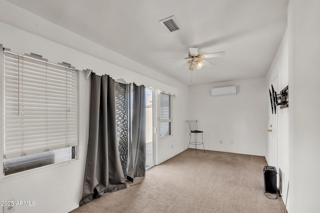 10806 N 114th Ave, Youngtown, AZ 85363 - carpeted empty room with a wall mounted AC, visible vents, and a ceiling fan