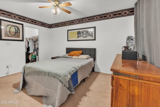 10806 N 114th Ave, Youngtown, AZ 85363 - bedroom featuring a closet, baseboards, ceiling fan, carpet floors, and a walk in closet