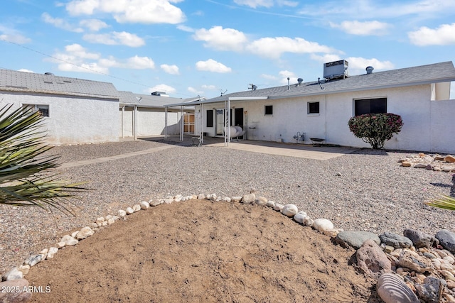 10806 N 114th Ave, Youngtown, AZ 85363 - back of property featuring stucco siding, a patio, and central AC