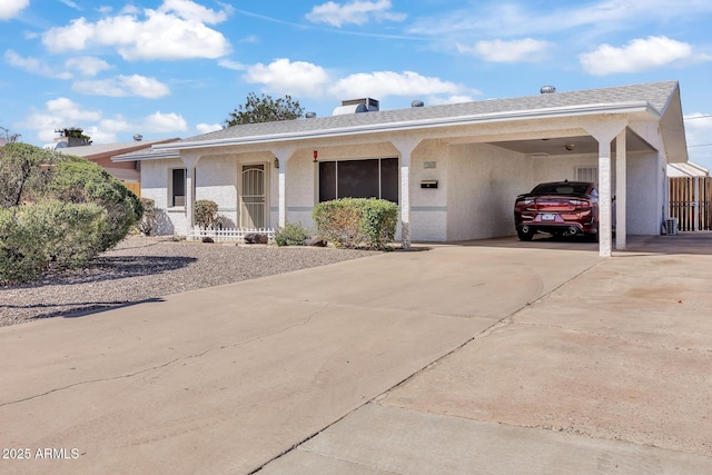 10806 N 114th Ave, Youngtown, AZ 85363 - single story home featuring an attached carport, concrete driveway, and stucco siding