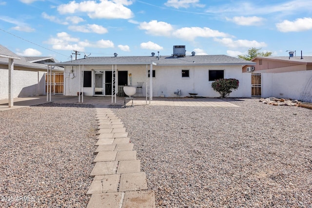 10806 N 114th Ave, Youngtown, AZ 85363 - back of house featuring cooling unit, stucco siding, fence, a gate, and a patio area