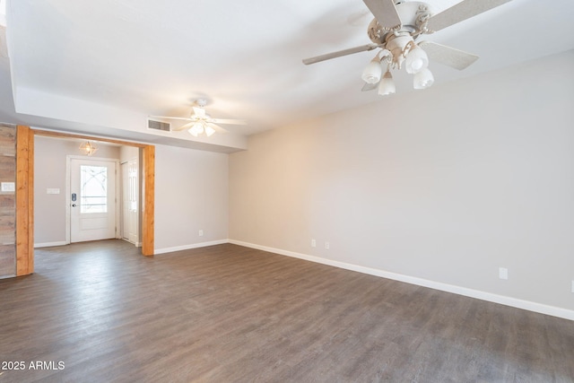 unfurnished room featuring baseboards, a ceiling fan, visible vents, and wood finished floors