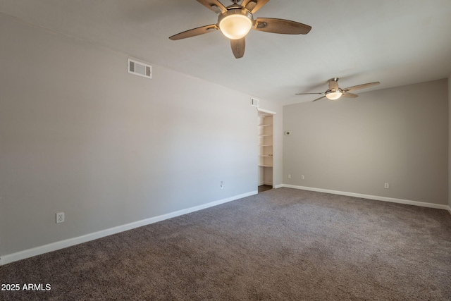 empty room with baseboards, carpet floors, a ceiling fan, and visible vents