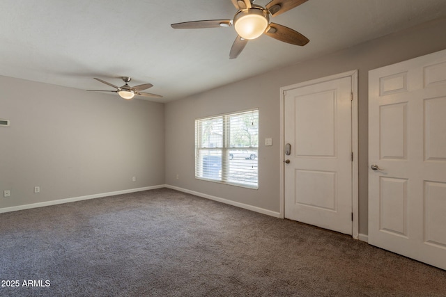 unfurnished room featuring carpet, visible vents, baseboards, and a ceiling fan