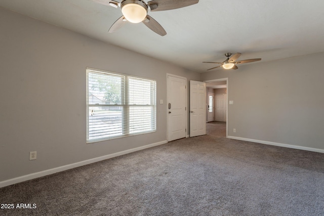 spare room with carpet flooring, baseboards, and a ceiling fan