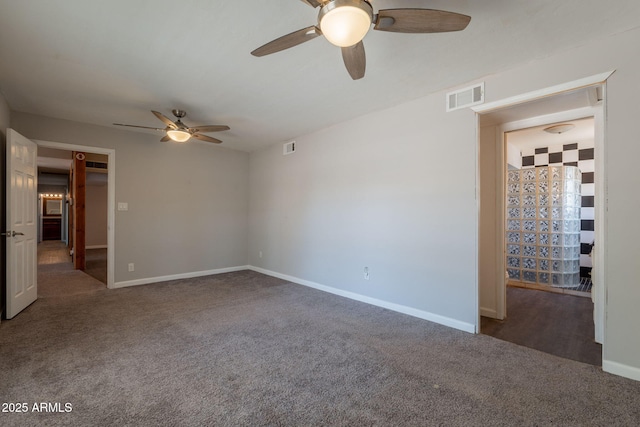 carpeted spare room with a ceiling fan, baseboards, and visible vents