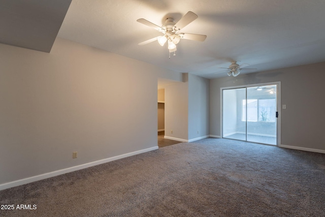 spare room featuring ceiling fan, dark colored carpet, and baseboards