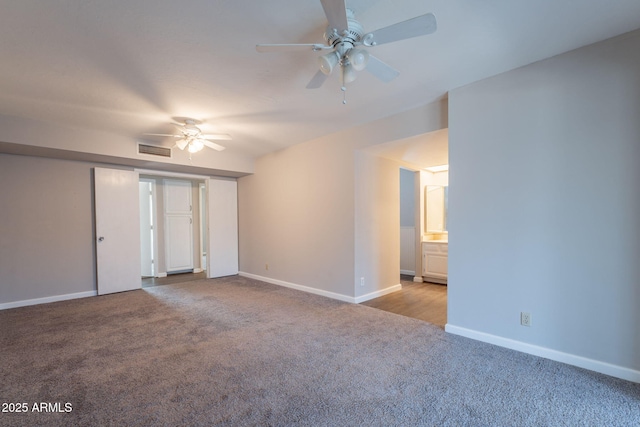 empty room featuring carpet flooring, visible vents, baseboards, and ceiling fan