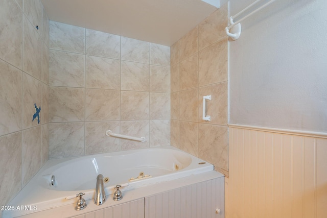 full bathroom with a tub with jets