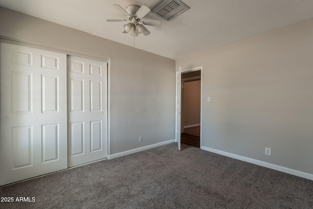 unfurnished bedroom with a closet, visible vents, baseboards, and carpet floors