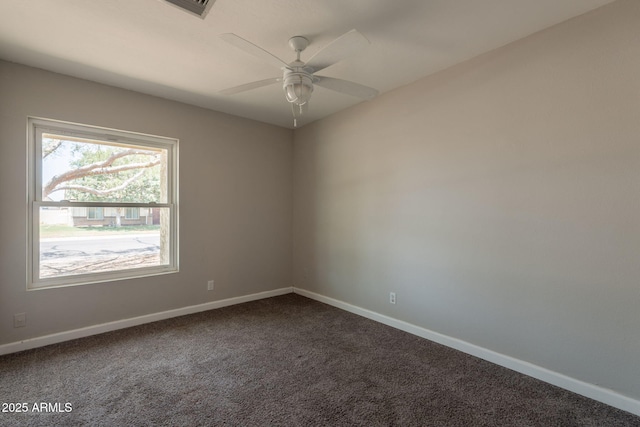 empty room with baseboards, ceiling fan, and carpet floors