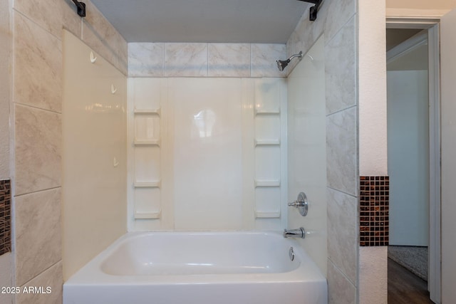 bathroom with shower / tub combination and tile walls