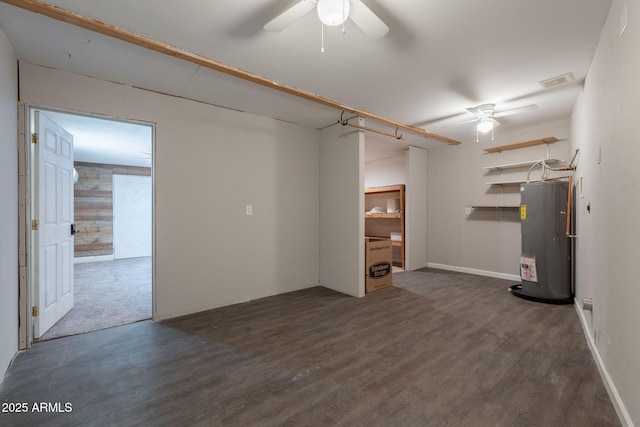 basement with water heater, wood finished floors, and a ceiling fan