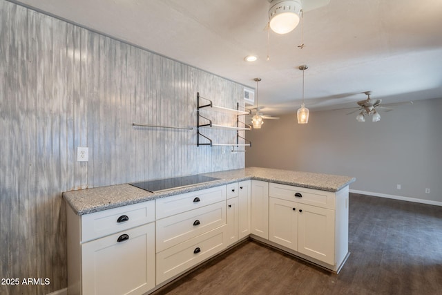 kitchen with black electric stovetop, open shelves, dark wood-type flooring, ceiling fan, and white cabinets