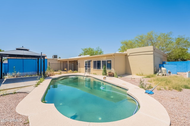 view of swimming pool with a gazebo, fence, a fenced in pool, and a patio area