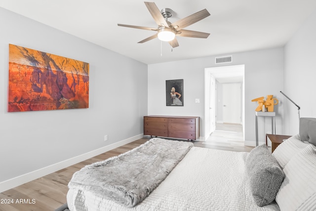 bedroom with ceiling fan and light hardwood / wood-style floors